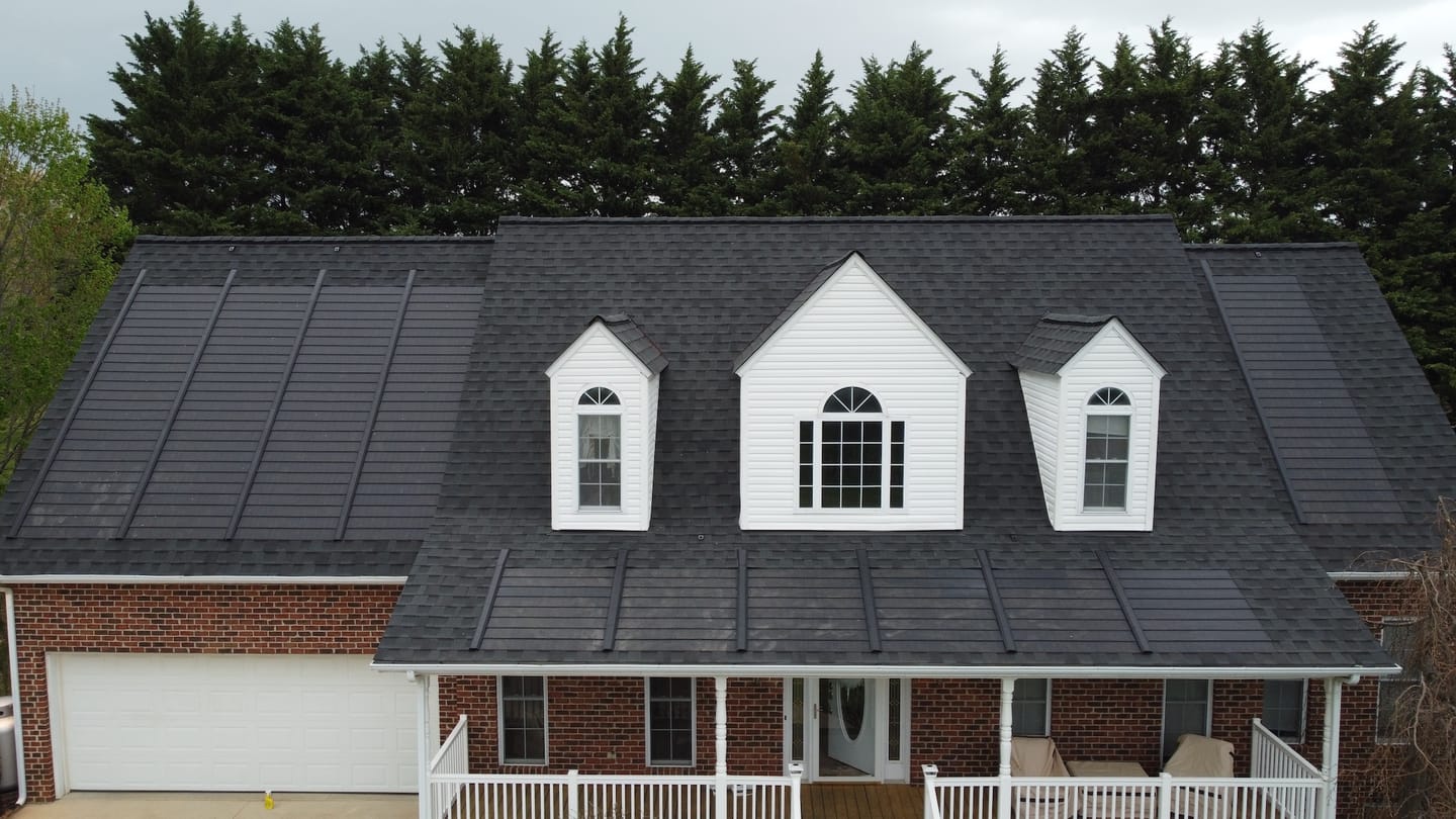 Home with three dormers and a dark GAF Timberline Solar shingle roof
