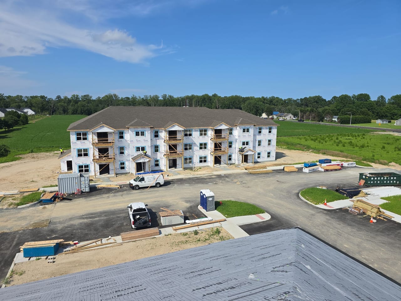 New three-story apartment building at Chapel Branch, seen from a freshly shingled roof