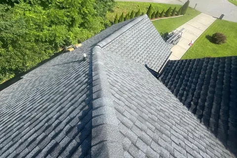 New gray architectural shingles and ridge caps on a home Panda Exteriors re-roofed