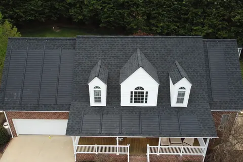 A home with a GAF solar shingle roof and three dormers, seen from above