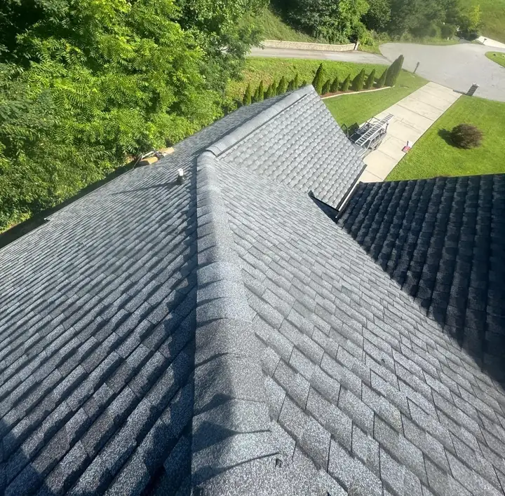 New gray architectural shingles and ridge caps on a home Panda Exteriors re-roofed