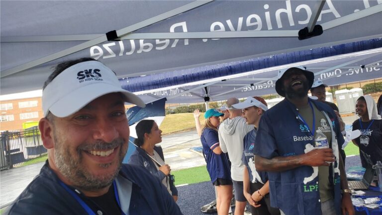 Volunteers in So Kids Soar visors at a baseball event