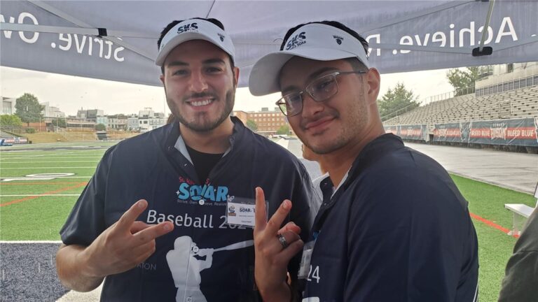 Two So Kids Soar baseball volunteers at the stadium