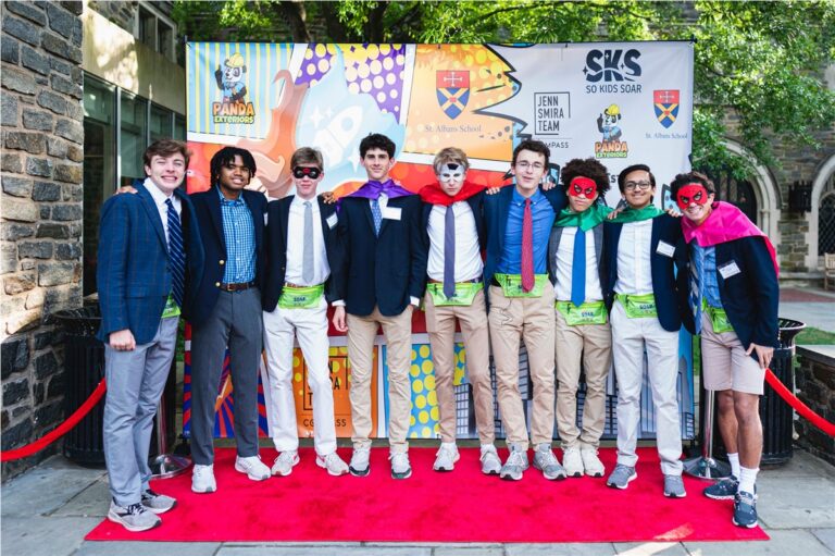 Students in superhero masks and capes on the So Kids Soar red carpet