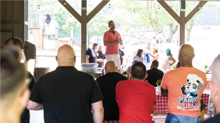 Guests under a pavilion at a Panda-sponsored cookout