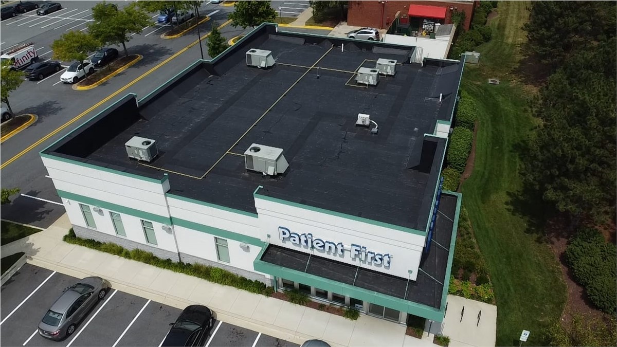 Aerial view of a new flat roof Panda Exteriors installed on a medical center